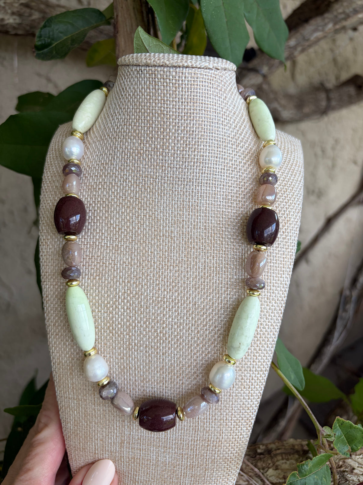 Mixed stone necklace on bust showing gold lobster clasp