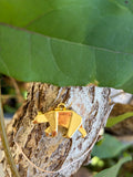 Gold origami bear charm with jump ring bail on tree bark