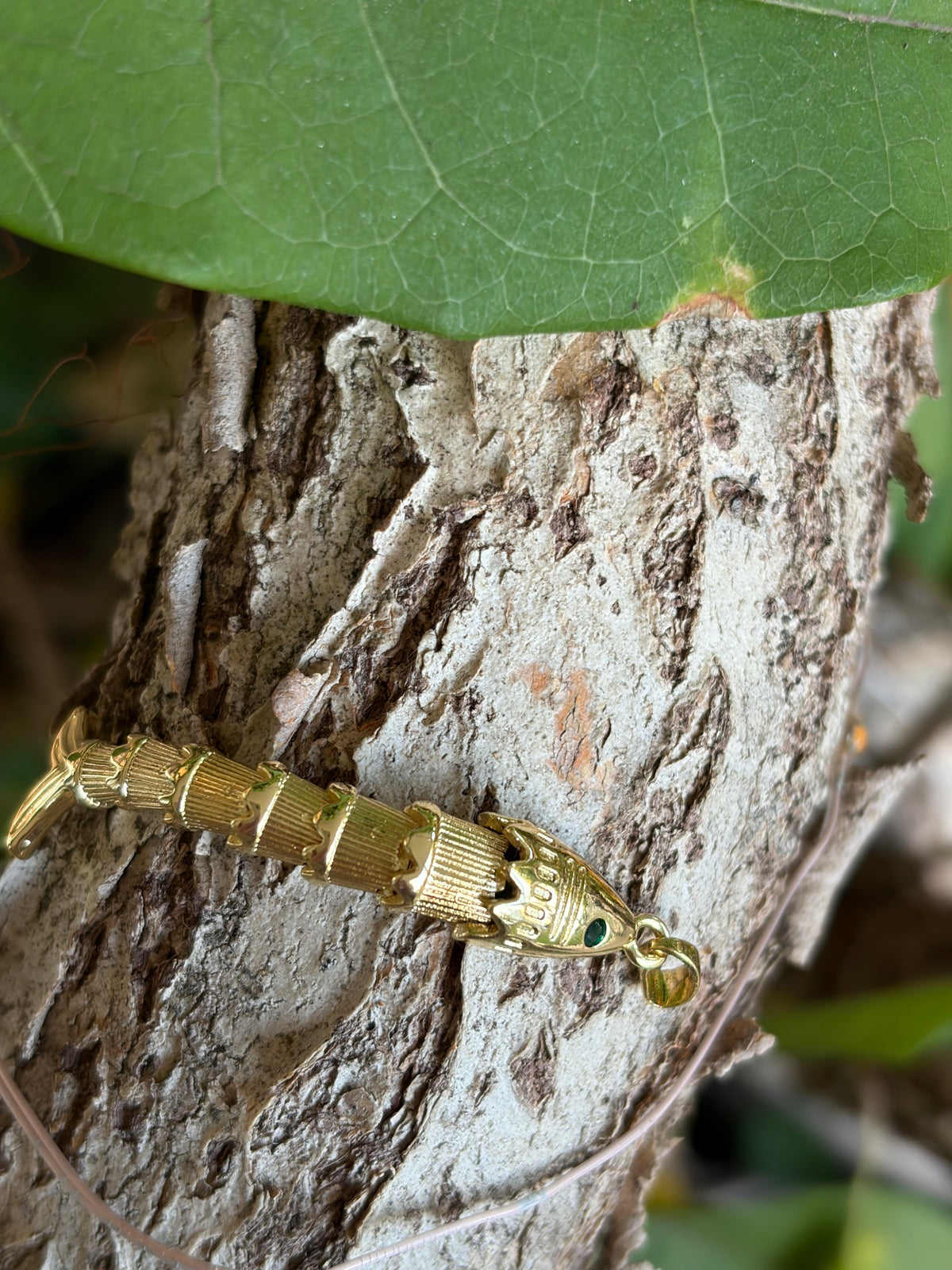 Gold Articulated Fish Charm with Emerald Eye