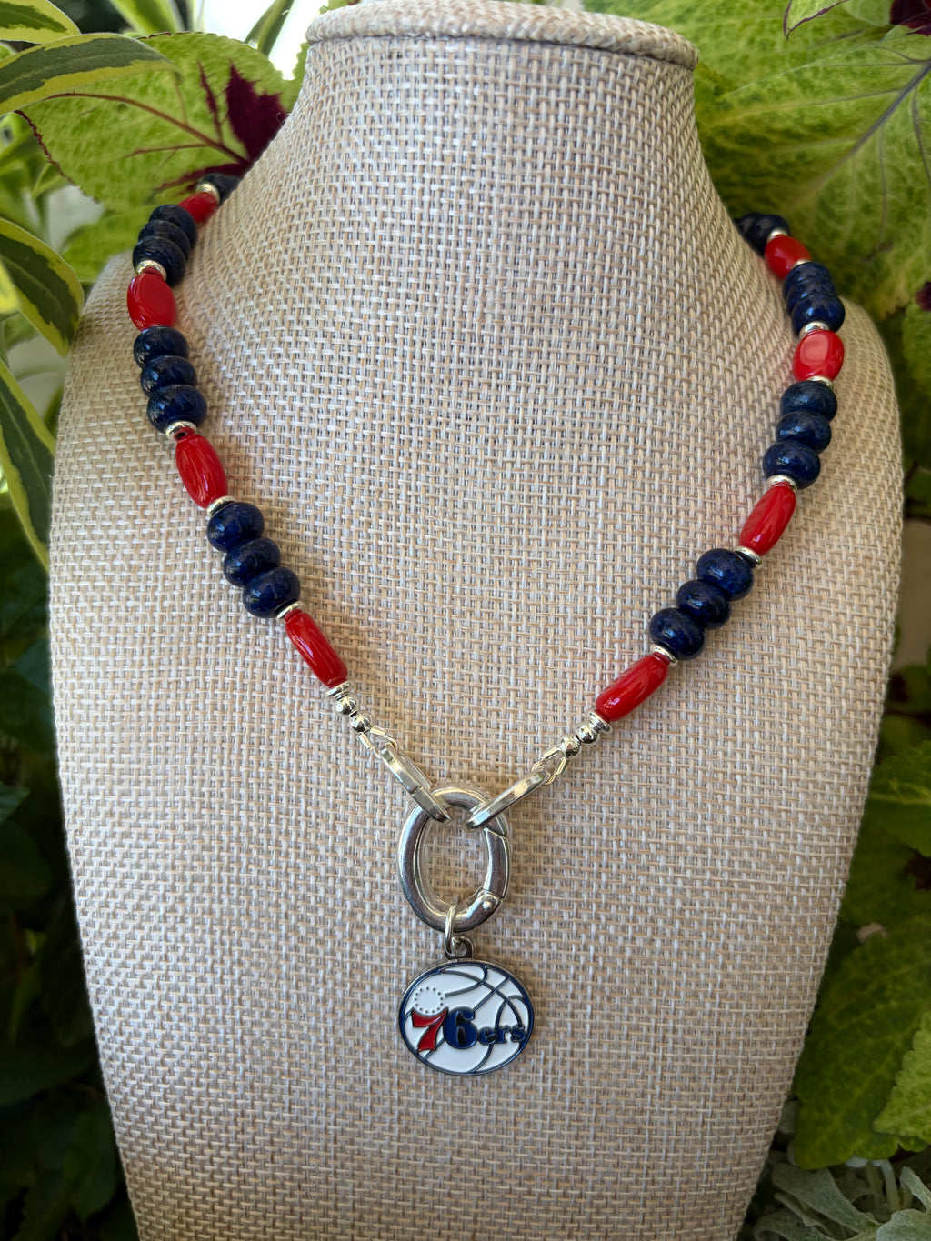 Lapis and red rice bead 76ers necklace with silver toggle clasp on mannequin bust