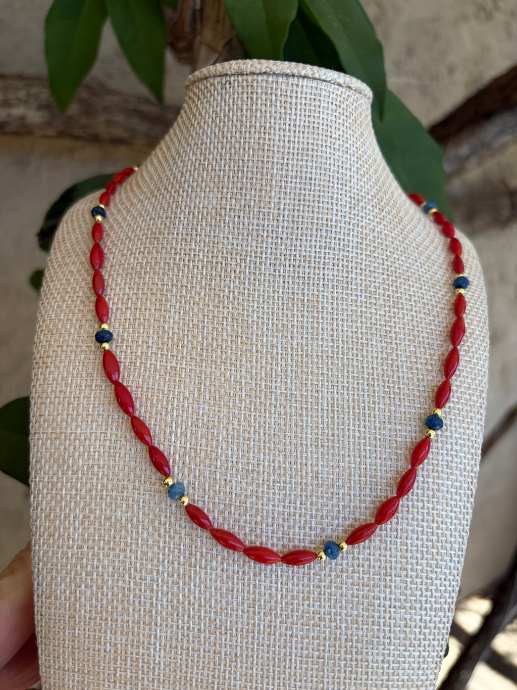 Red rice bead and lapis necklace on mannequin bust