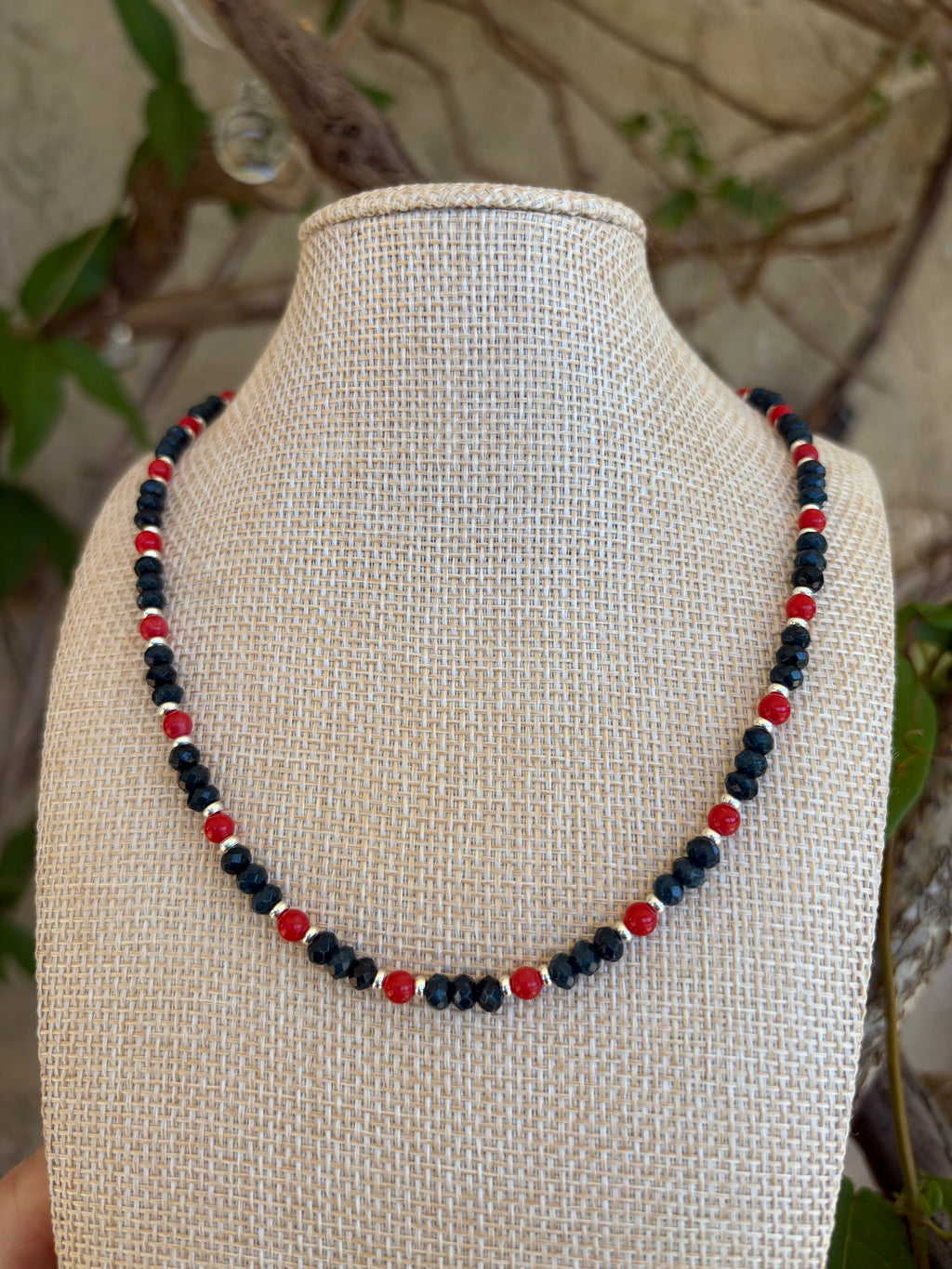 Navy crystal and red bead necklace on mannequin bust front view