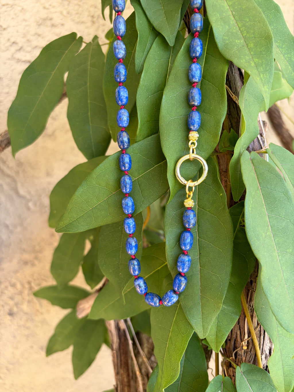 Lapis lazuli beaded necklace on mannequin bust side view