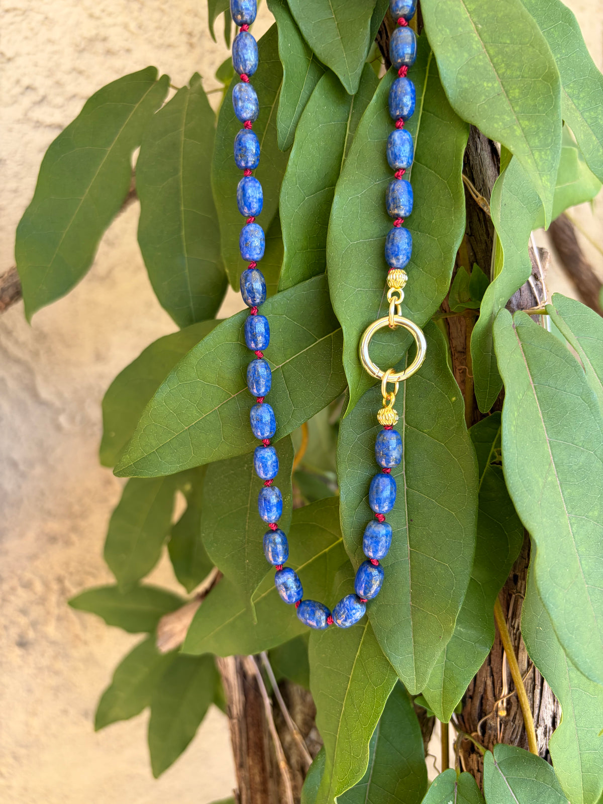 Lapis lazuli beaded necklace on mannequin bust side view